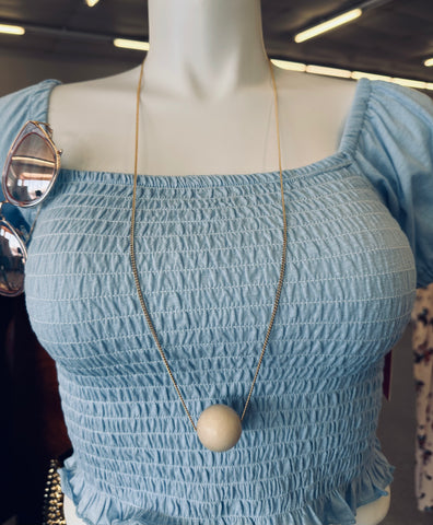 long Gold necklace with large cream bead